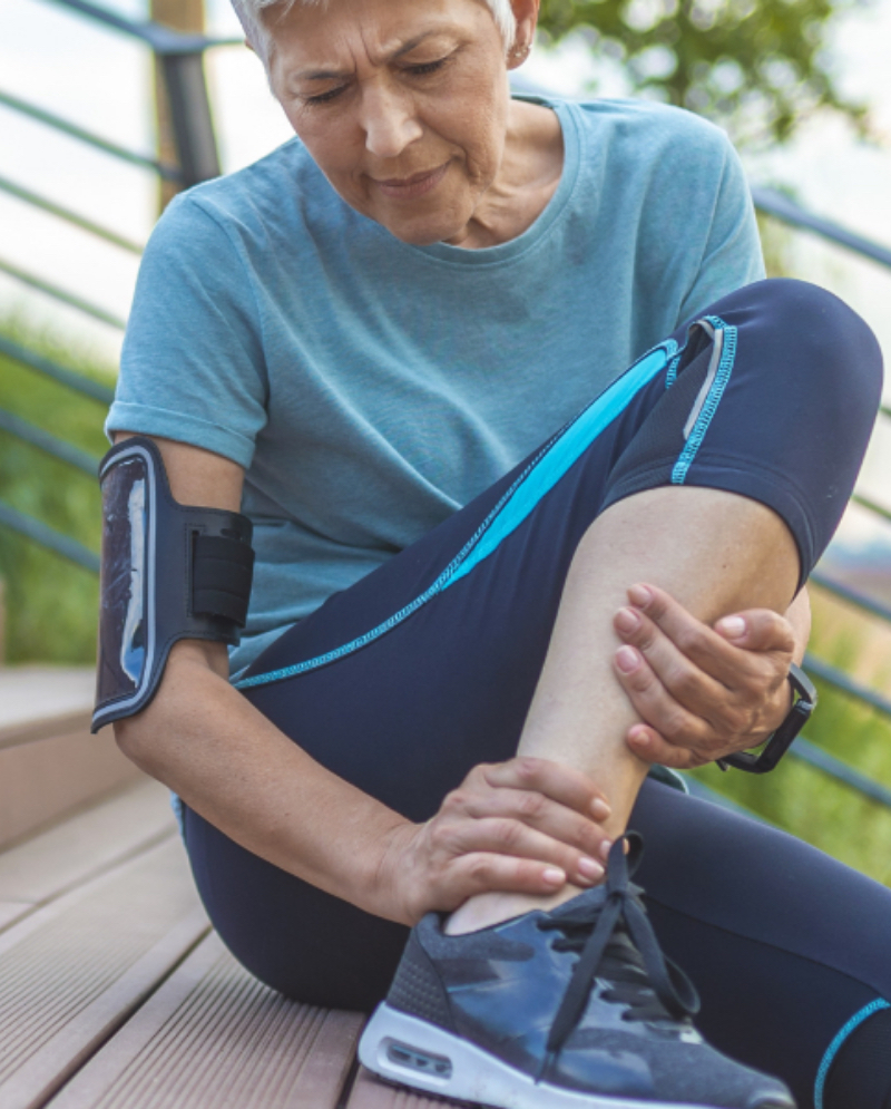 Woman holding her ankle