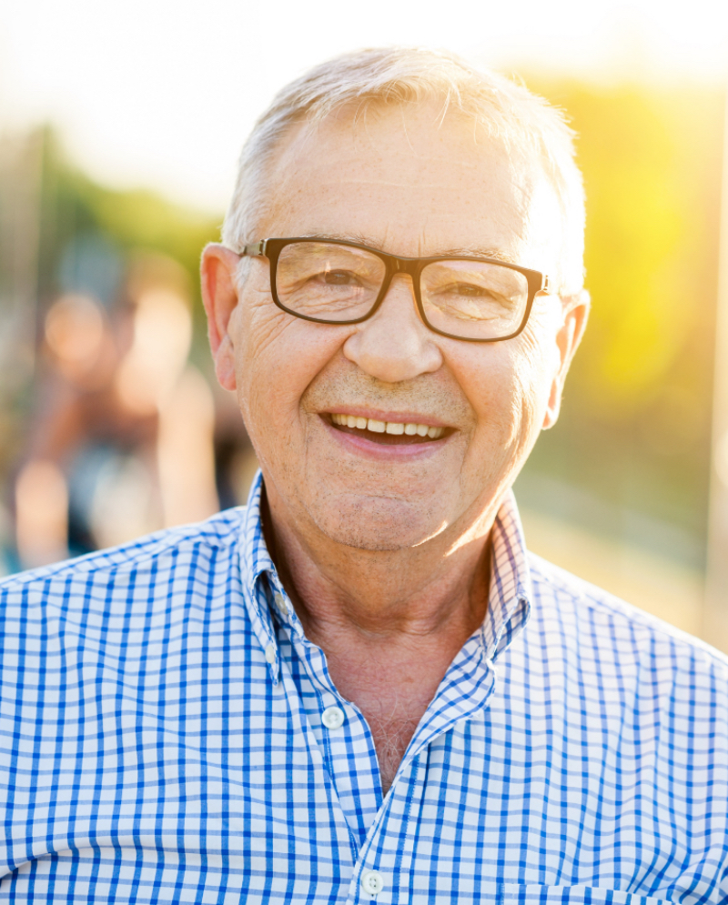 Old man with glasses smiling