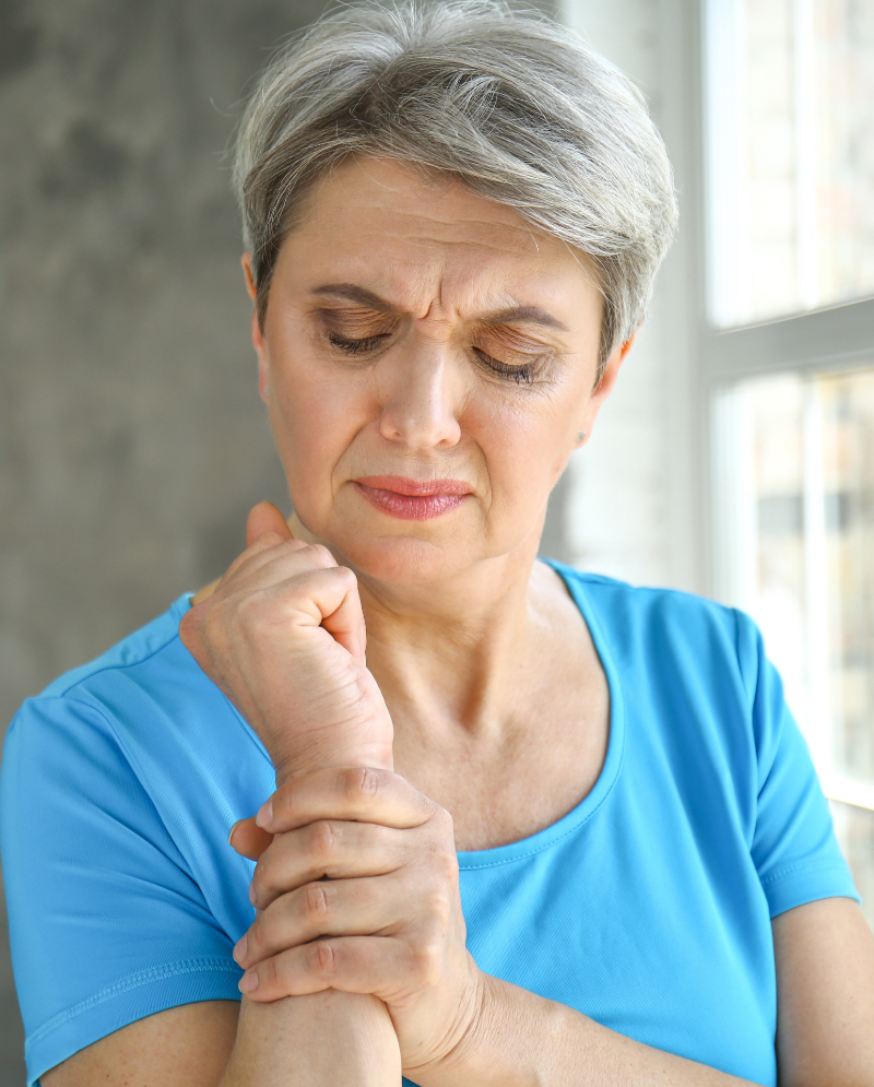 Woman touching her forearm