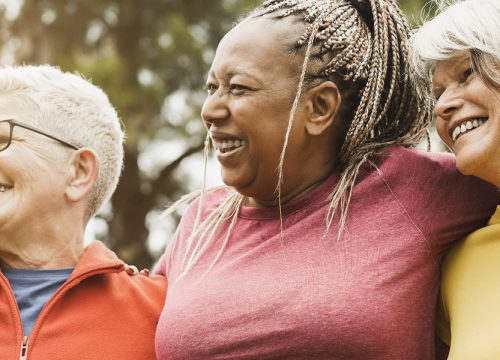 Older women huddled together smiling