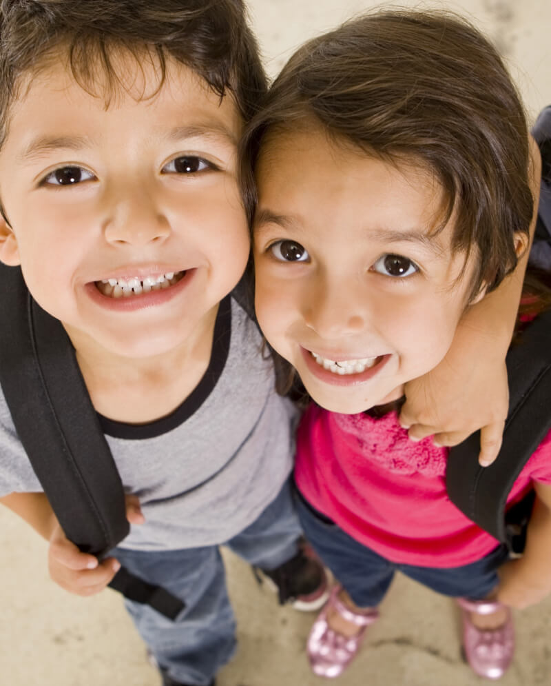 Two little boys hugging and smiling