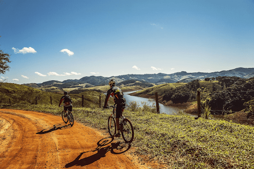 two men riding bike in nature 