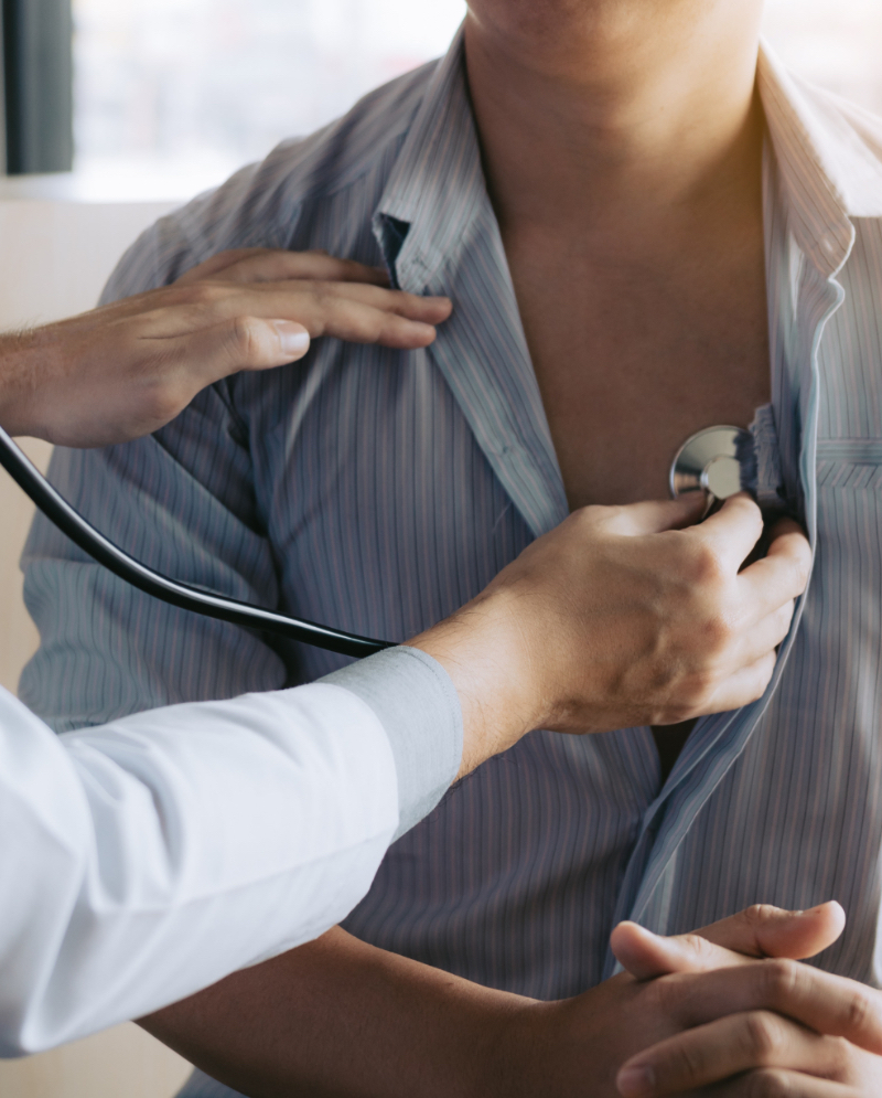 A person getting checked by a doctor using a stethoscope