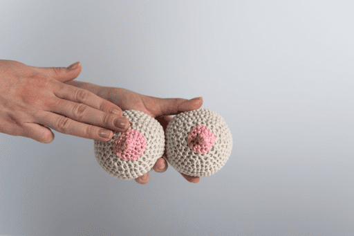 Hands showing how to check for breast cancer